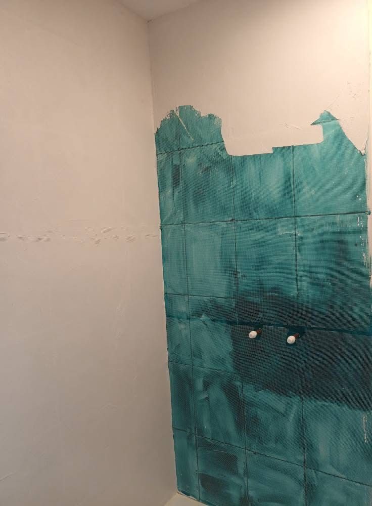 Old green tiles being coated over, no need to remove them